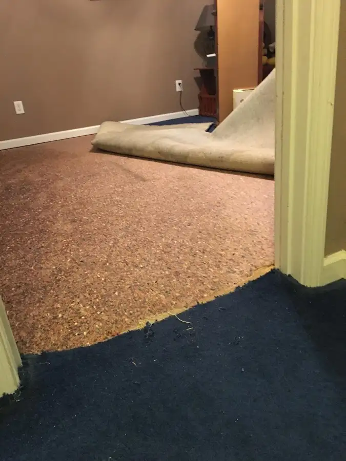Carpet pad removal revealing water damage during Drying & Dehumidification in Portage Lakes